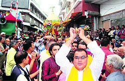 Devotees sing in praise of Lord Krishna during a procession in Mussoorie on Sunday