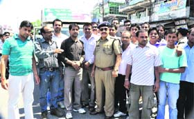 Volunteers of the Uttarakhand Kranti Dal (P) standing with a truckload of relief material in Haridwar