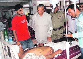 Vidhan Sabha Speaker Tulsi Ram enquires about a victim at the Regional Hospital in Chamba