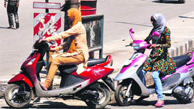 Girls riding scooters are a common sight in Srinagar.