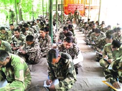 BSF jawans take part in a essay writing competition on the eve of International Youth Day in Poonch. A Tribune photograph