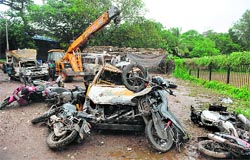 Vehicles damaged during Saturdays violence in Azad Maidan, Mumbai.  AFP