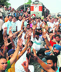 Protesters stage a dharna on a railway track in Patiala on Sunday