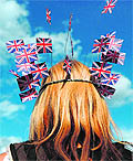 A British fan wears a fancy cap