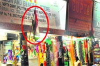 As per rule, the Tricolour should be taken down after sunset. But it seems that the owner of the shop is not aware of the rule. tribune photo: pradeep tewari