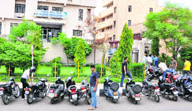Vehicles parked on the main road in front of the BSNL customer care office at Bahu Plaza in Jammu.