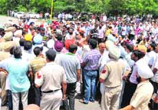 Beopar Bachao Sangharsh Committee members block traffic in Patiala on Monday.