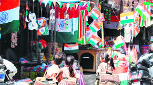 Schoolchildren keenly look at the Tricolour at a market in Amritsar on Tuesday. 