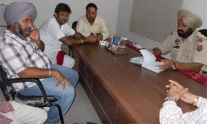 Range officer Tejinder Singh (left) at the police station.