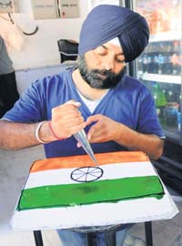 A baker prepares a Tricolour cake in Panchkula