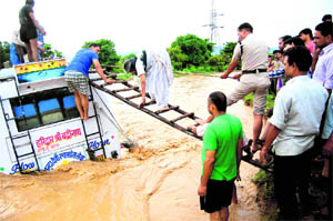 The police rescues passengers from a bus caught in flood waters in Haridwar on Tuesday.