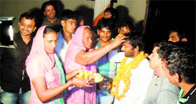 Shushila Devi welcomes her son Yogeshwar Dutt at the family house in Bhainswal Kalan village on Tuesday.