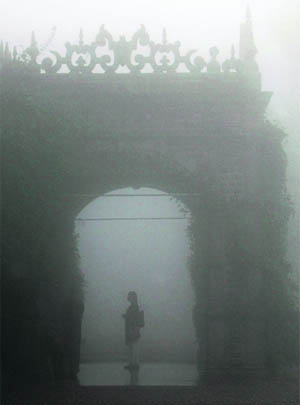 A girl stands in dense fog at the Indian Institute of Advanced Study in Shimla.