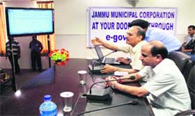 Deputy Chief Minister Tara Chand opens the website of the Jammu MC in Jammu