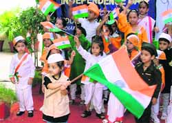 Tiny tots of Kiddies Paradise hold Tricolours in their hands during the Independence Day function in Ludhiana on Tuesday. 