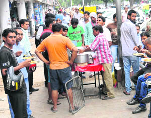 Roadside vendors encroach upon a footpath at Sector 22-B in Chandigarh.