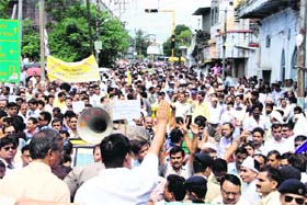 Members of the Uttarakhand Adhikari Karamchari Shikshak Sangharsh Morcha take out a protest march in Dehradun on Thursday