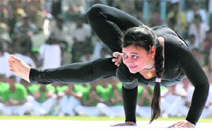  A policewoman performs yoga at Karan Stadium in Karnal. 