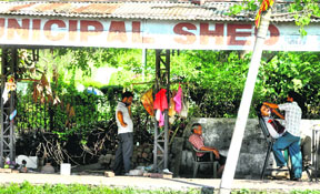 Brazen misuse: A rain shelter being used by a barber to run his business.