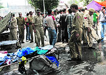 Policemen remove stalls put up by vendors on a road near Clock Tower at Lal Chowk in Srinagar on Thursday. The police action led to a protest by vendors who claimed they were selling goods ahead of Eid festival