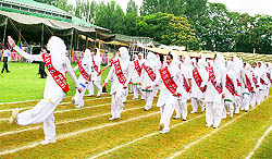 A march past by schoolgirls during the Independence Day function at Bakshi Stadium