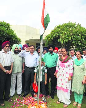 Members of the Indian Medical Association salute the national flag on Independence Day in Ludhiana