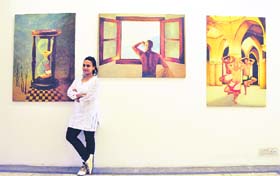 Saru S with her paintings at Artmosphere Art Gallery in Ludhiana