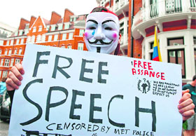 A supporter of Julian Assange holds a banner outside the Ecuador Embassy in London on Thursday.