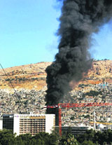 Smoke billows from the scene of an explosion outside a Damascus hotel where UN observers are staying. 