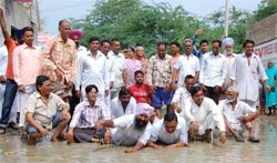 A file photo of the residents of Lal Singh Basti who squatted in the accumulated water to voice their protest.