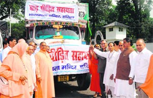 Chief Minister Vijay Bahuguna flags off a truck carrying relief material collected by the Bharat Mata Mandir for the Uttarkashi cloudburst victims in Dehradun on Friday. 