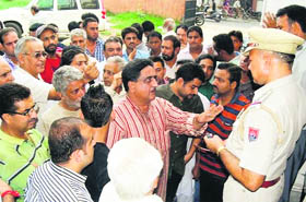Residents, who gheraoed the Division No 5 police station in protest against the delay in the arrest of accused ASI, booked in an abetment to suicide case, talk with  police officers in Jalandhar on Friday. 