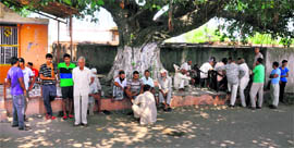 Panic-stricken villages of Chandu Chack gather under a banyan tree. The villagers refused to go to their fields near the Indo-Pak border.