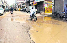 Rainwater accumulates on College Road after a brief spell of rain in Ludhiana.