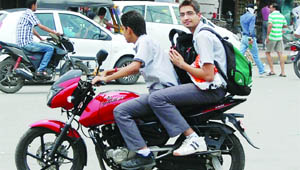 Schools boys take traffic norms for a ride without any fear of being caught.