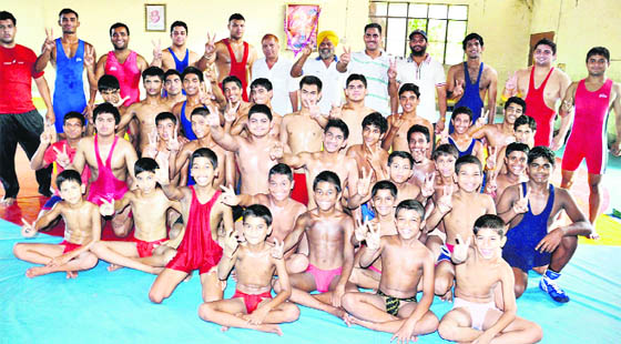 Budding wrestlers celebrate the good show put up by Indian wrestlers at the London Olympics, in Amritsar. 