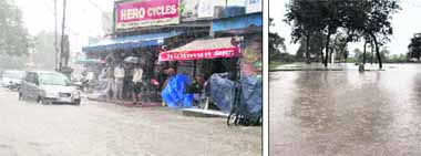 The Clock Tower area turns into a rivulet following a heavy rain in Dehradun on Saturday; and (right) water enters Manjara. 