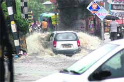 A car wades through a water-logged Bhagat Singh Chowk railway under-bridge in Haridwar on Saturday; 