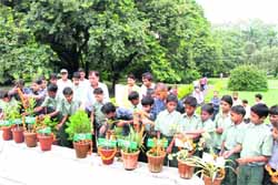 Children pay tributes to the students of Sumangarh School who died in 2010 at a programme organised by Maiti organisation at Gandhi Park in Dehradun on Saturday.