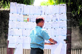 A vendor displays job application forms for sale in Jammu.