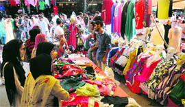 shoppers take a look at clothes ahead of Eid-ul-Fitr at a busy market in Srinagar on Saturday. Markets across the Kashmir valley are witnessing a huge rush as Ramadan draws to a close.