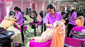 A beautician gives a facial treatment at a salon in Srinagar. Beauty parlours are offering an array of packages to draw women this Eid.