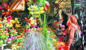People shop in a busy market in the Lal Chowk area of Srinagar ahead of Eid-ul-Fitr on Saturday.