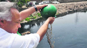 A file photo of Union Minister Jairam Ramesh releasing microbial culture in Buddha Nullah in Ludhiana on April 23, 2011.