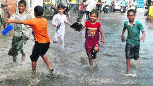 Children make the most of a rainy spell in Patiala on Saturday.