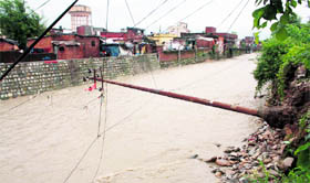 The Rispana in spate in Dehradun on Sunday.