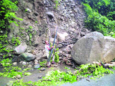 Boulders fall due to a landslide at Saat Meel near Pandoh on the Mandi-Kullu road on Sunday.