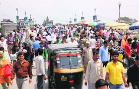 Shoppers throng the Amarakadal Bridge, near Lal Chowk, to make purchases for Eid-ul-Fitr in Srinagar on Sunday
