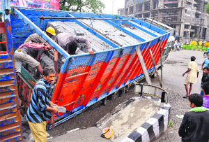 The truck being unloaded before being pulled out by a crane. 