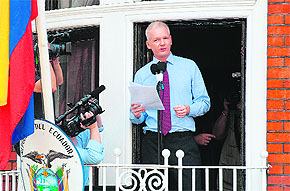 WikiLeaks founder Julian Assange addresses the media and his supporters from the balcony of the Ecuadorian Embassy in London on Sunday.